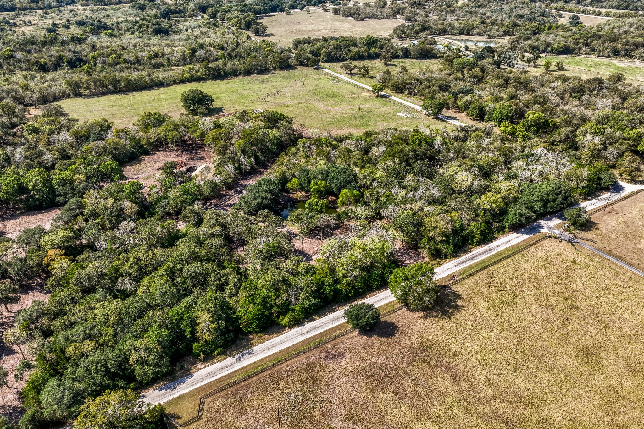6 Sun Oil Road Brenham, TX 77833 - Photo 34 of 34 an aerial view of a house with a yard and lake view
