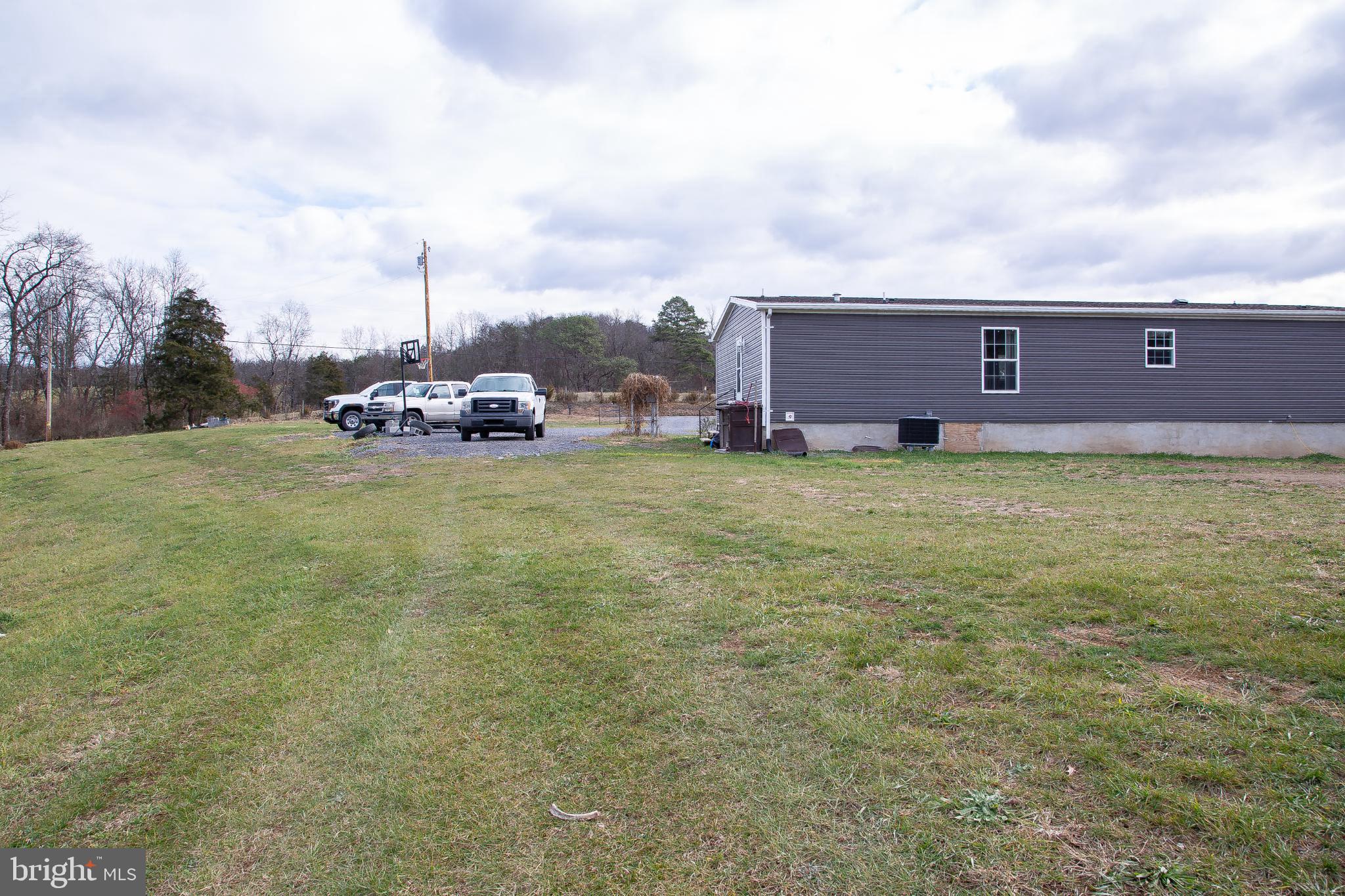 1101 Beaver Run Road Burlington, WV 26710 - Photo 33 of 40 a view of a house with a big yard and large trees