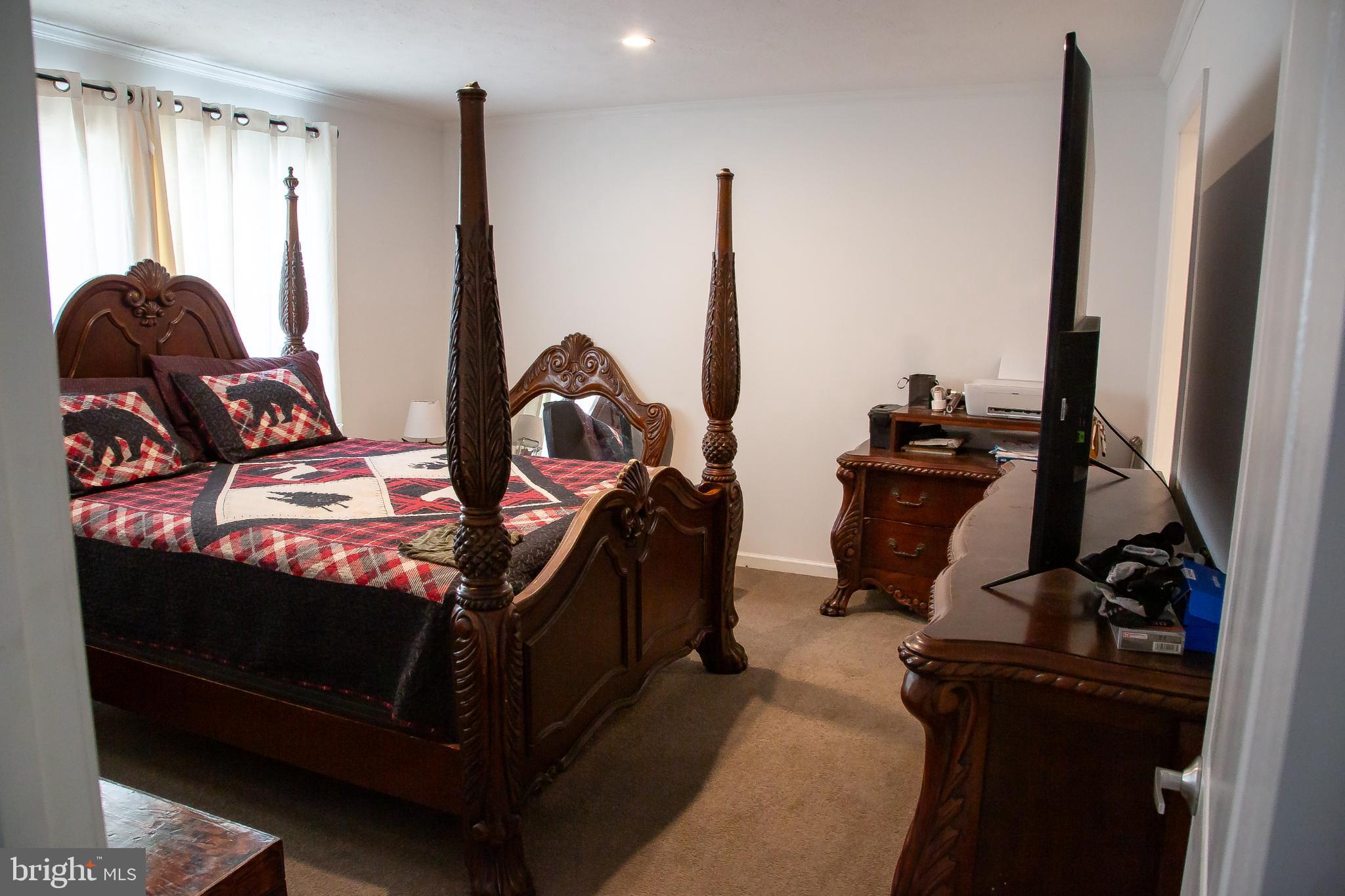 1101 Beaver Run Road Burlington, WV 26710 - Photo 10 of 40 a bed sitting in a room next to a window