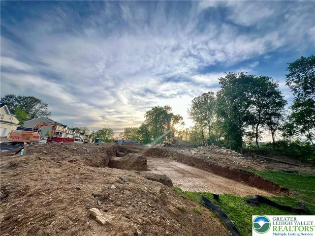 a view of a yard with wooden fence