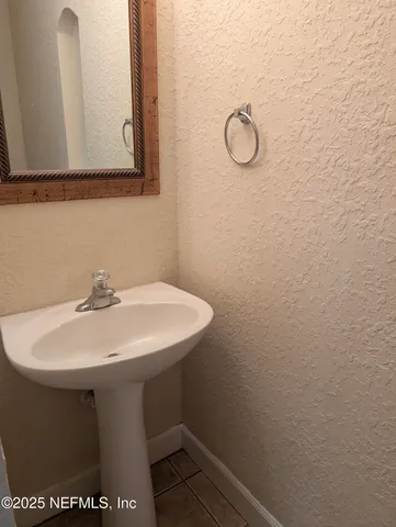 a bathroom with a sink and mirror