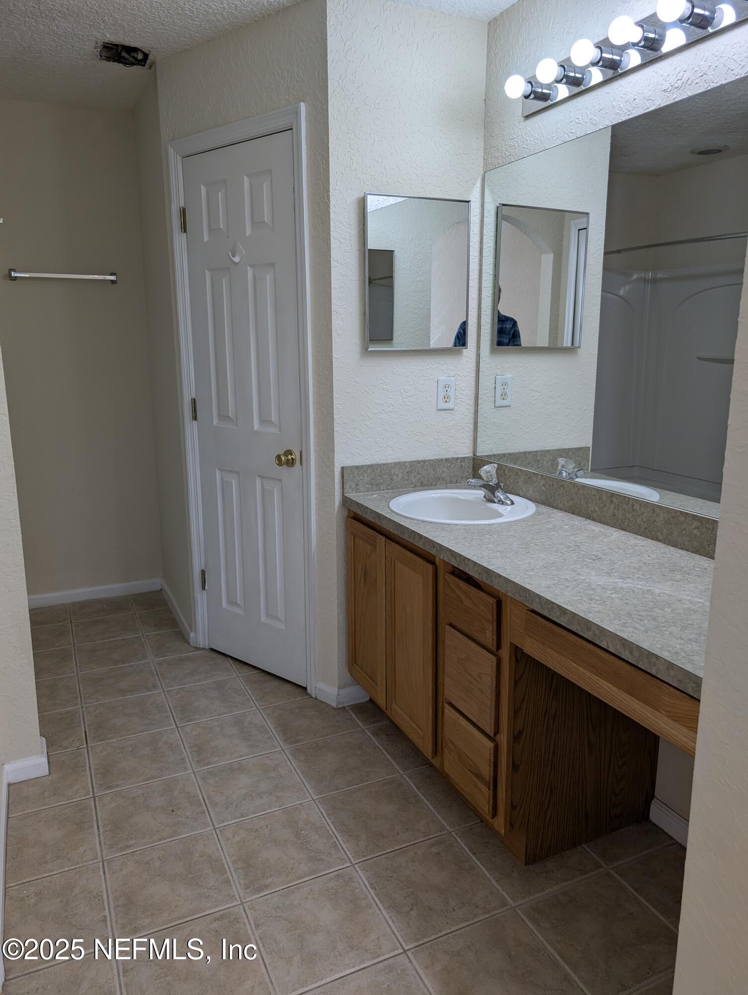 1811 Lago Del Sur Drive Middleburg, FL 32068 - Photo 8 of 10 a bathroom with a granite countertop sink a mirror and a vanity