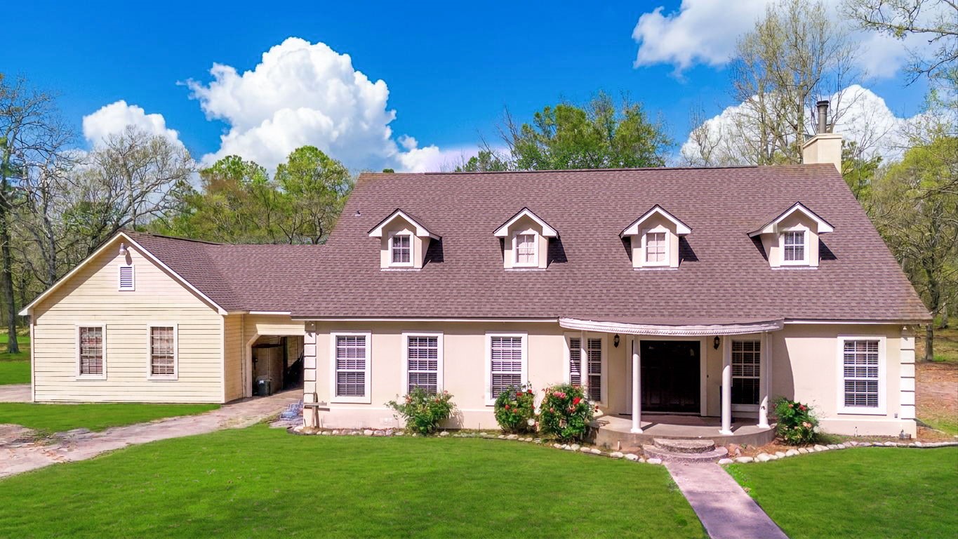 a view of a house with a yard and garden