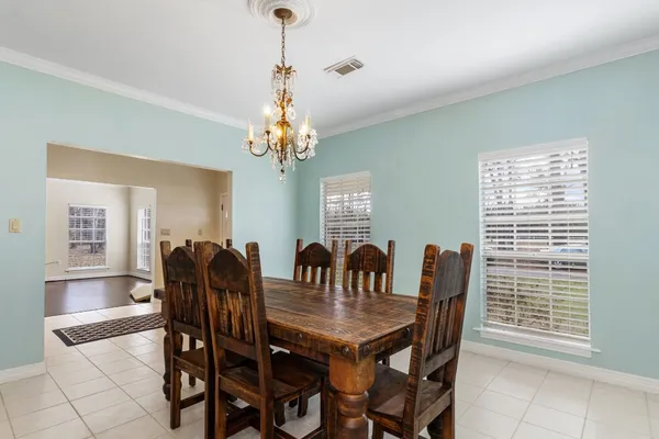 a view of a dining room with furniture and chandelier