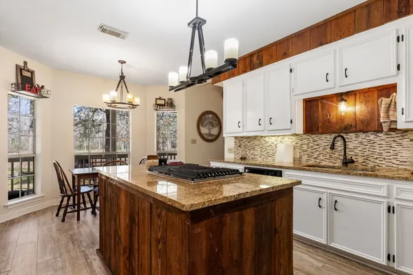 a kitchen with stainless steel appliances granite countertop a stove and a microwave