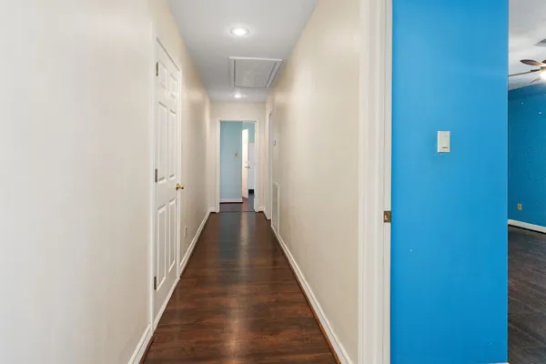 a view of a hallway with wooden floor
