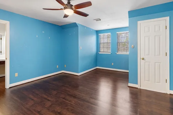 a view of room with hardwood floor and ceiling fan