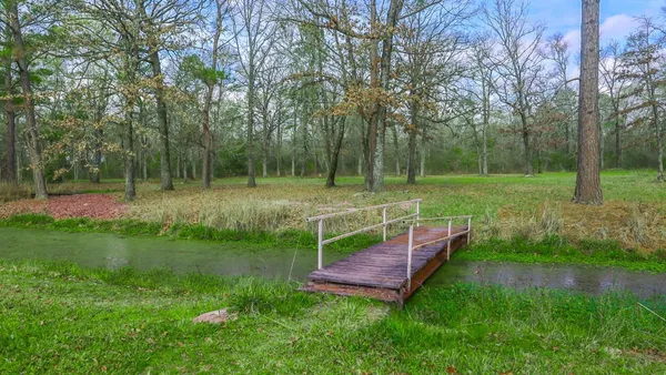 a view of outdoor space with deck and trees