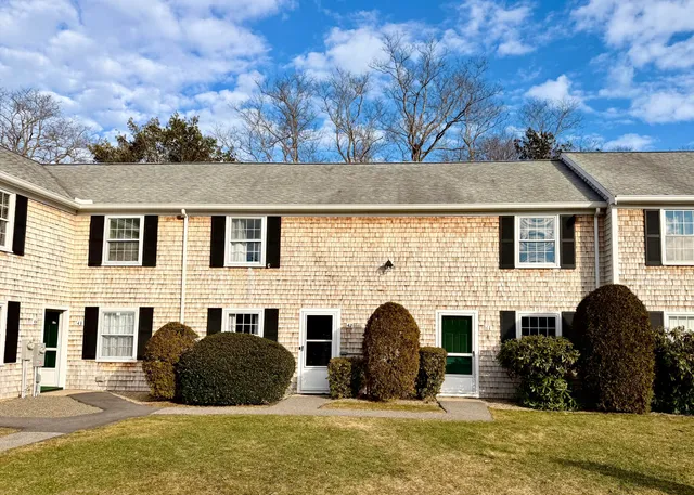 a front view of a house with yard and seating space