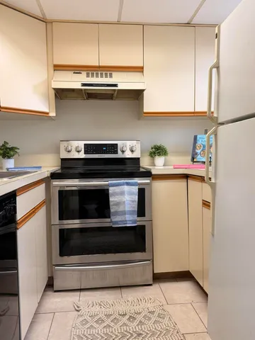 a kitchen with stainless steel appliances a stove and a refrigerator