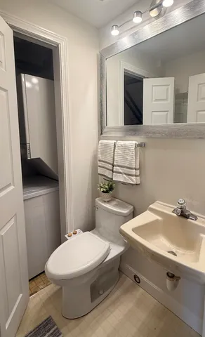 a bathroom with a sink a toilet and mirror