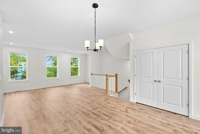 a view of a room with window and hardwood floor