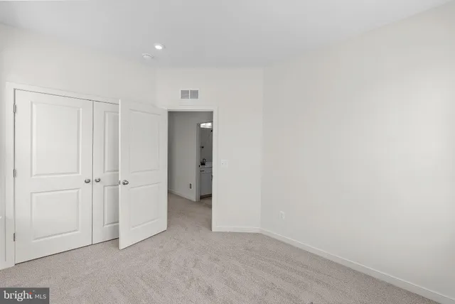 a bed room with a bed and a window