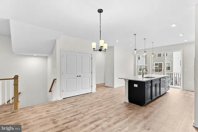 a view of kitchen and kitchen with granite countertop a sink