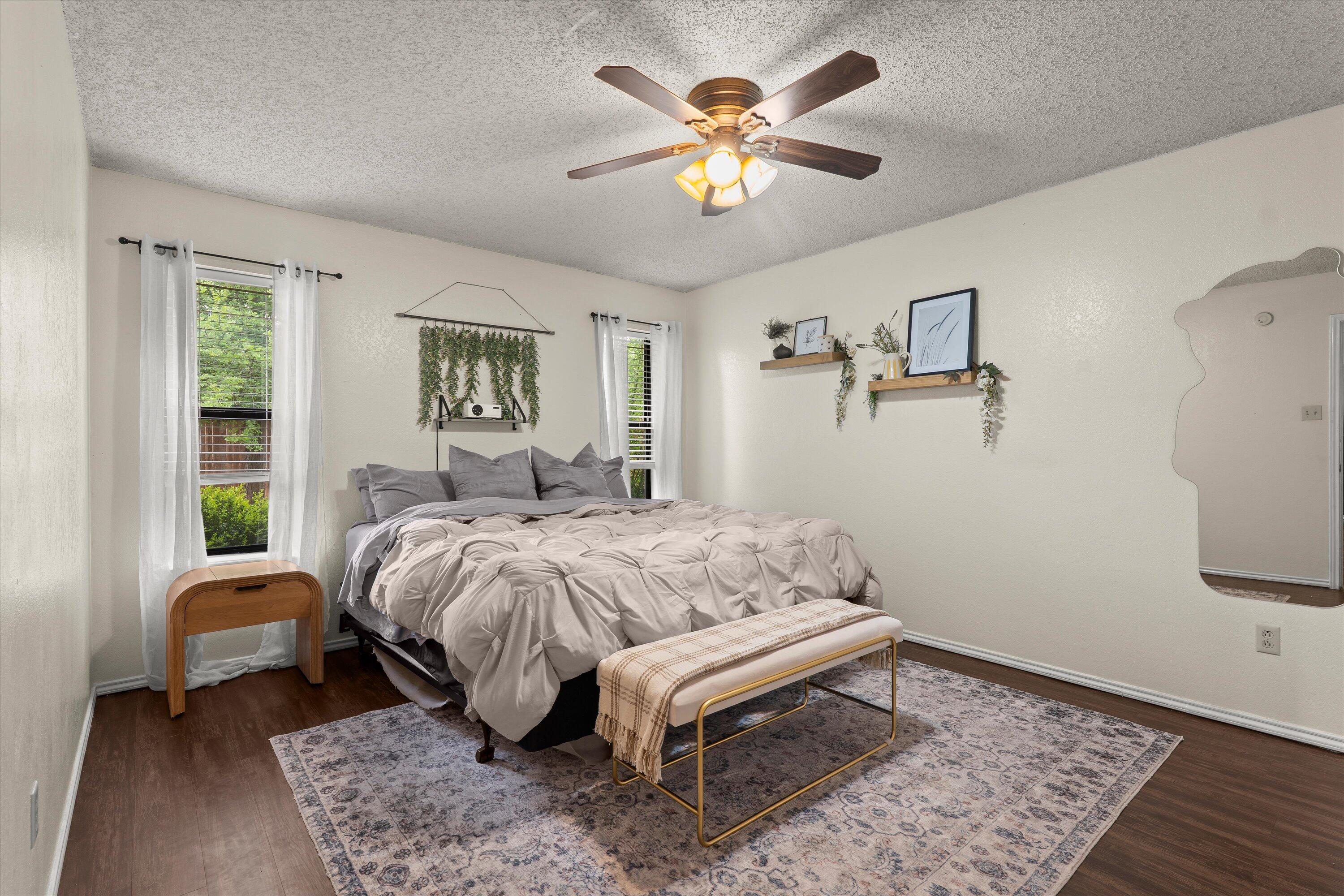 2308 93rd Street Lubbock, TX 79423 - Photo 14 of 28 a bedroom with a bed and a chandelier