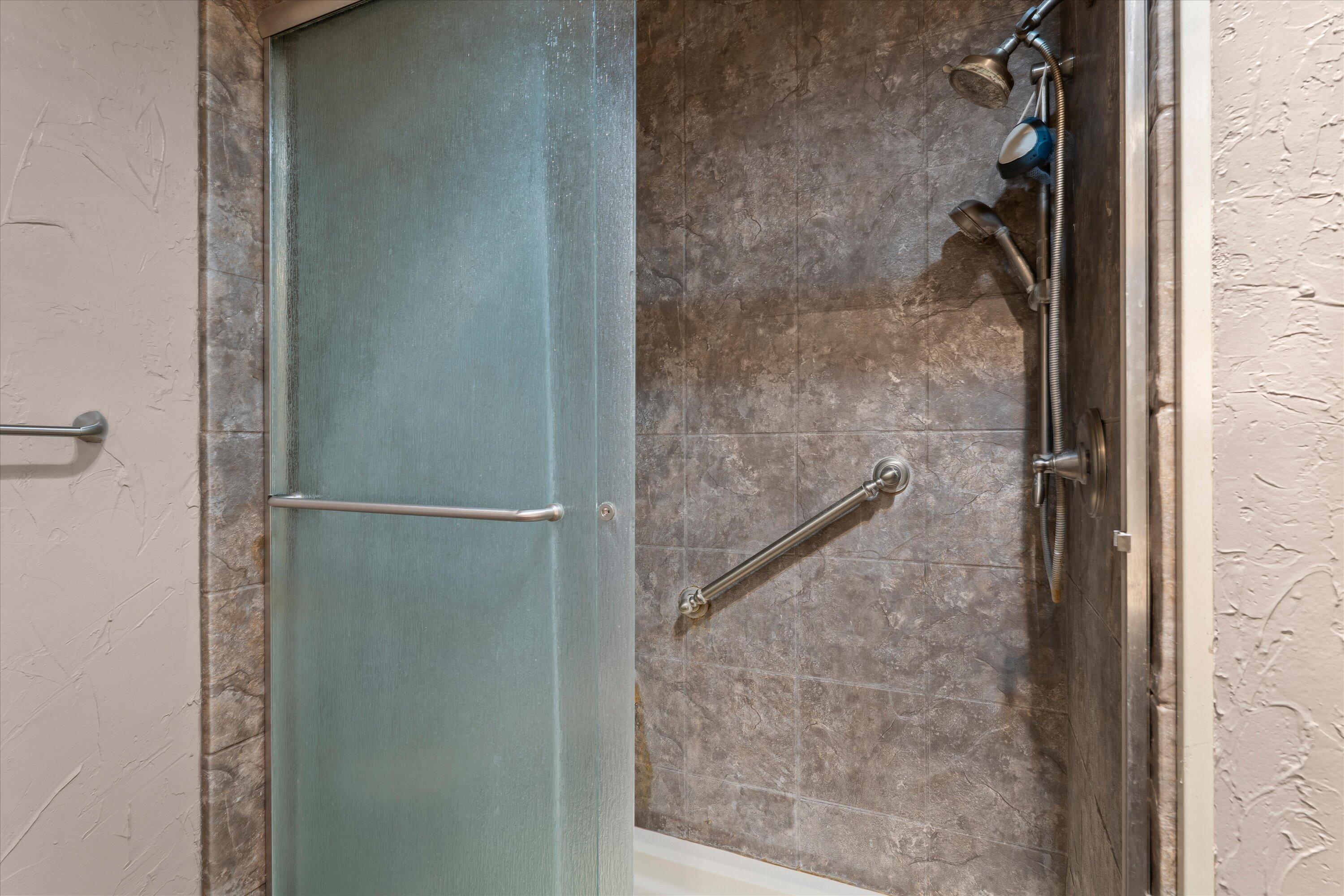 2308 93rd Street Lubbock, TX 79423 - Photo 17 of 28 a bathroom with a glass shower door