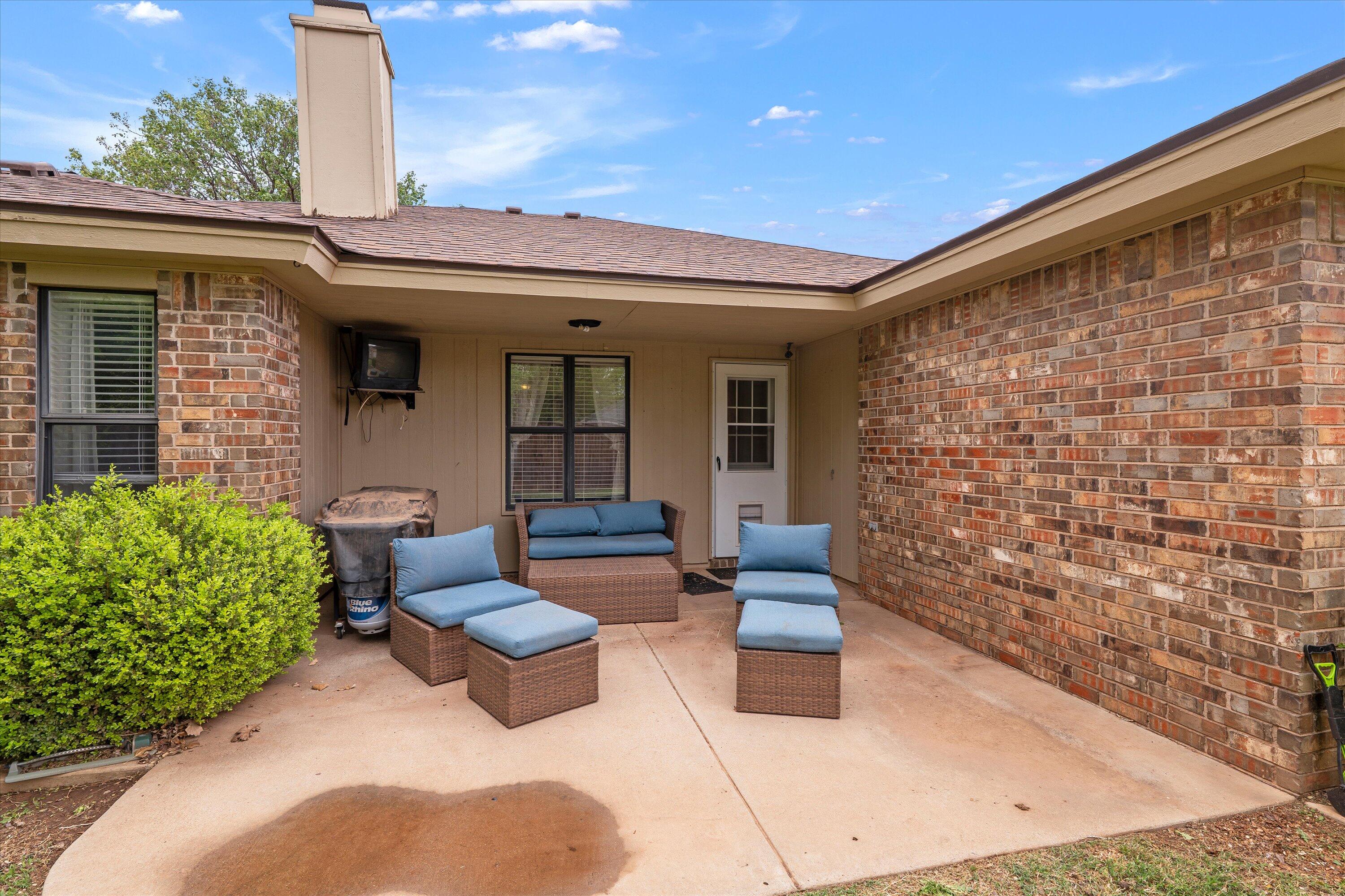 2308 93rd Street Lubbock, TX 79423 - Photo 23 of 28 a view of a patio with couches table and chairs and potted plants