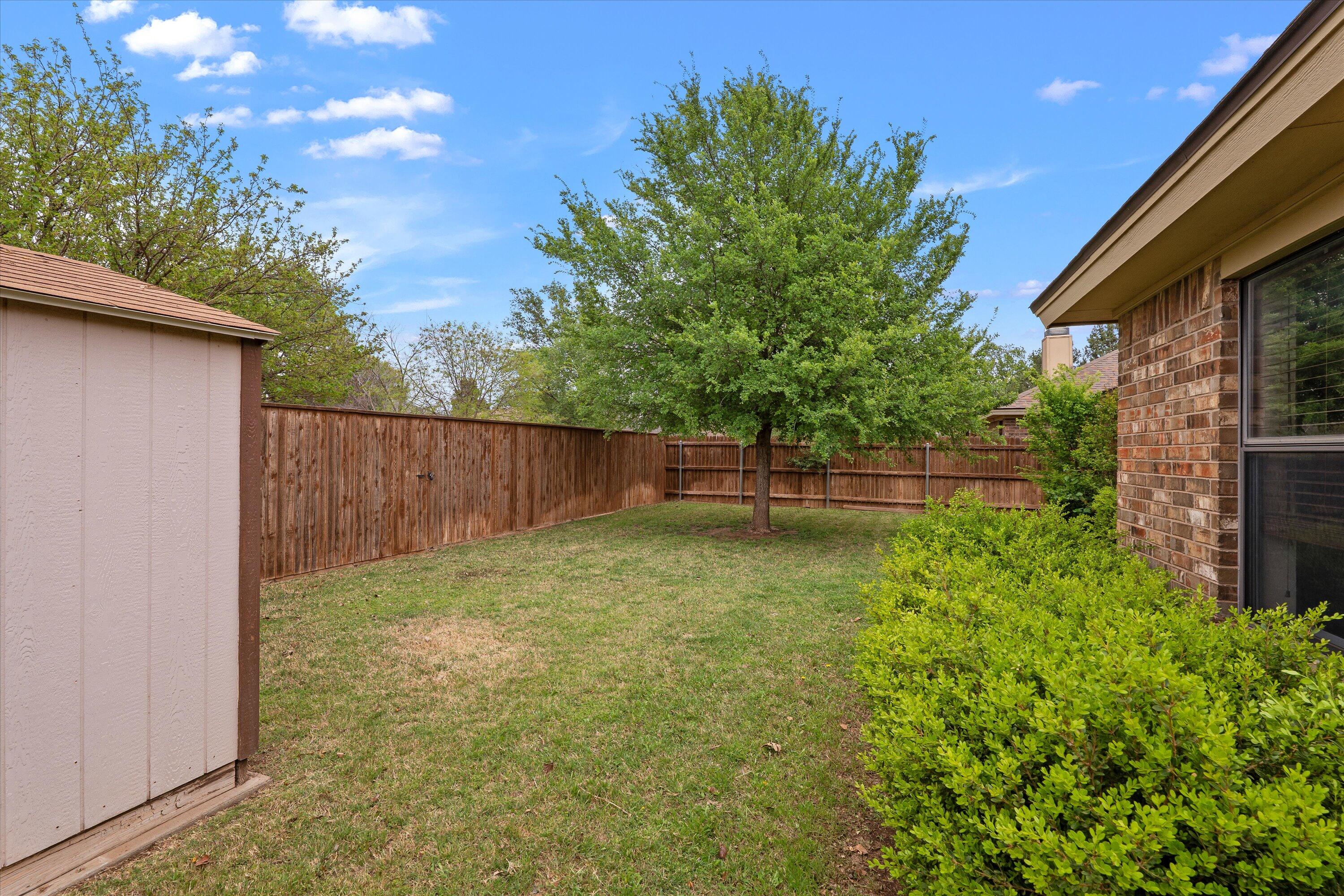 2308 93rd Street Lubbock, TX 79423 - Photo 24 of 28 a backyard of a house with lots of green space