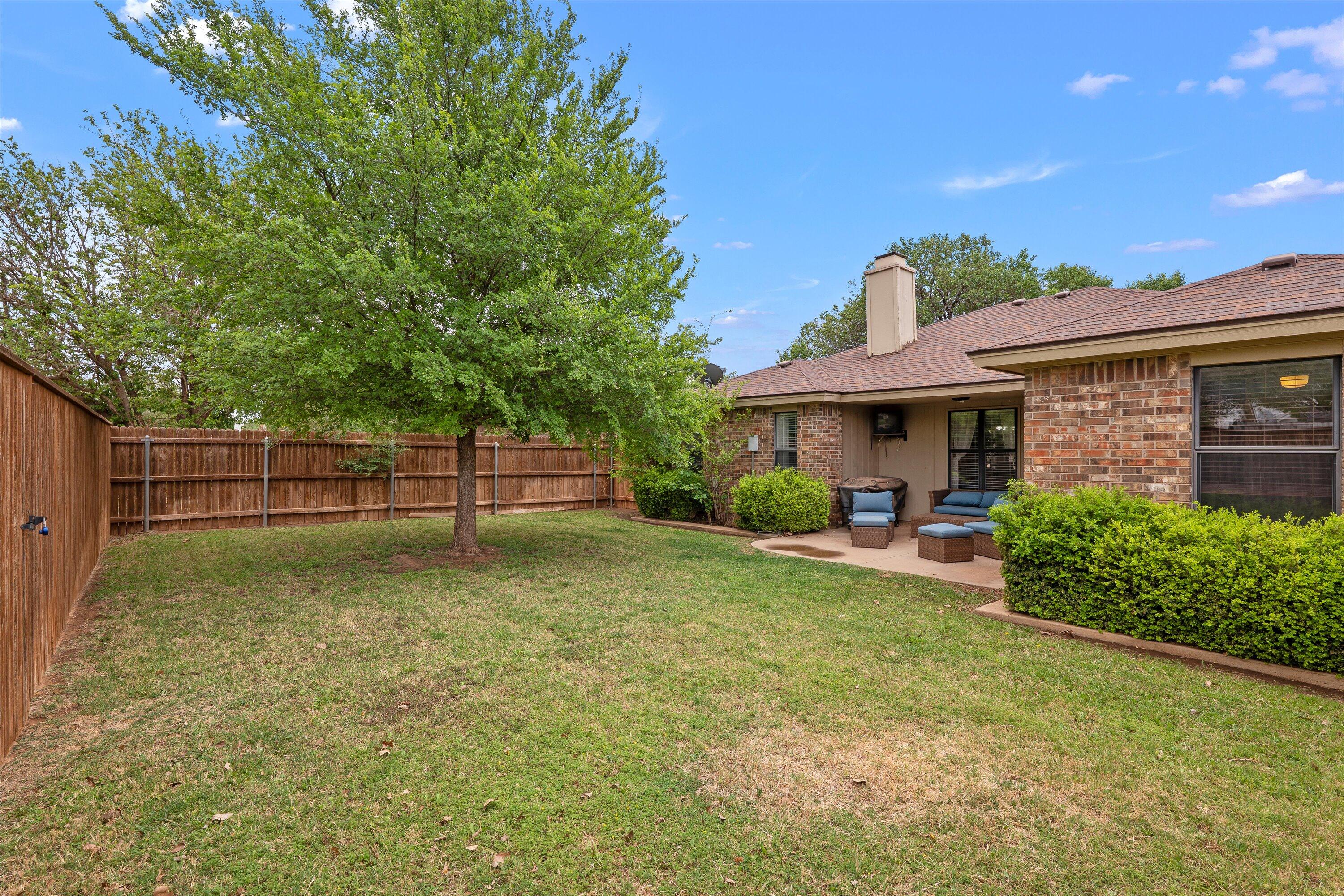 2308 93rd Street Lubbock, TX 79423 - Photo 25 of 28 a view of a house with backyard and a tree
