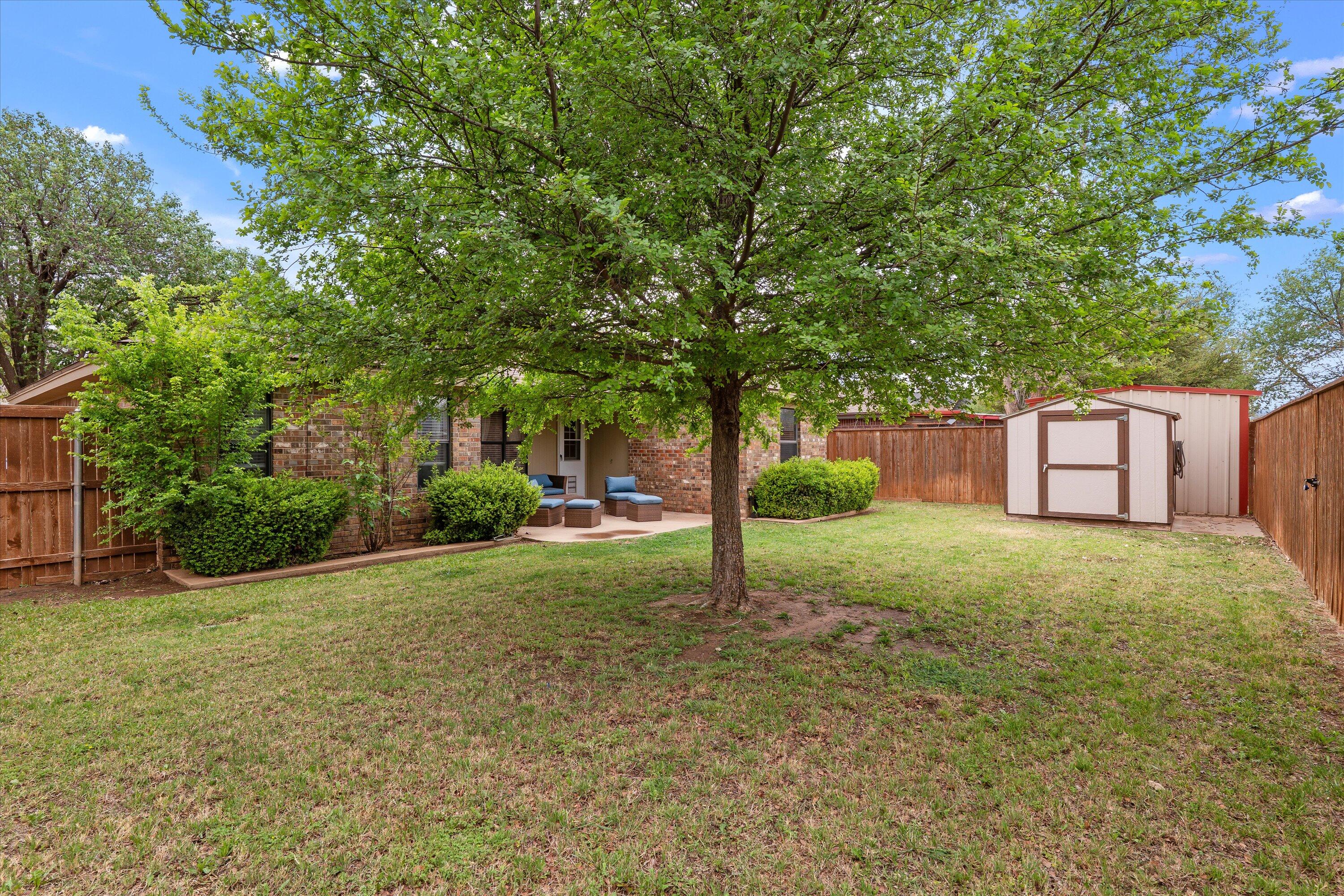 2308 93rd Street Lubbock, TX 79423 - Photo 26 of 28 a view of a house with backyard and trees