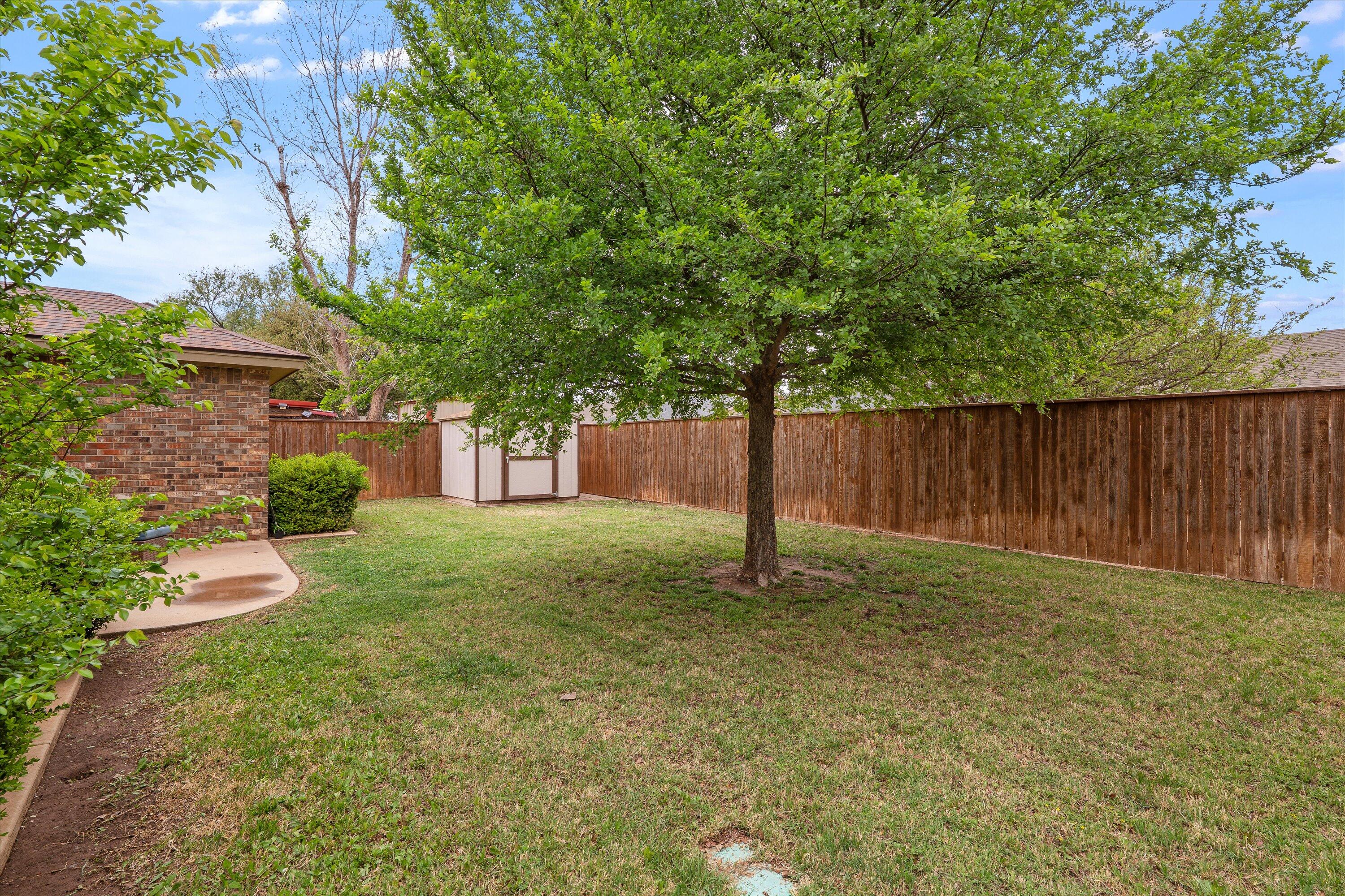 2308 93rd Street Lubbock, TX 79423 - Photo 27 of 28 a view of backyard with tree