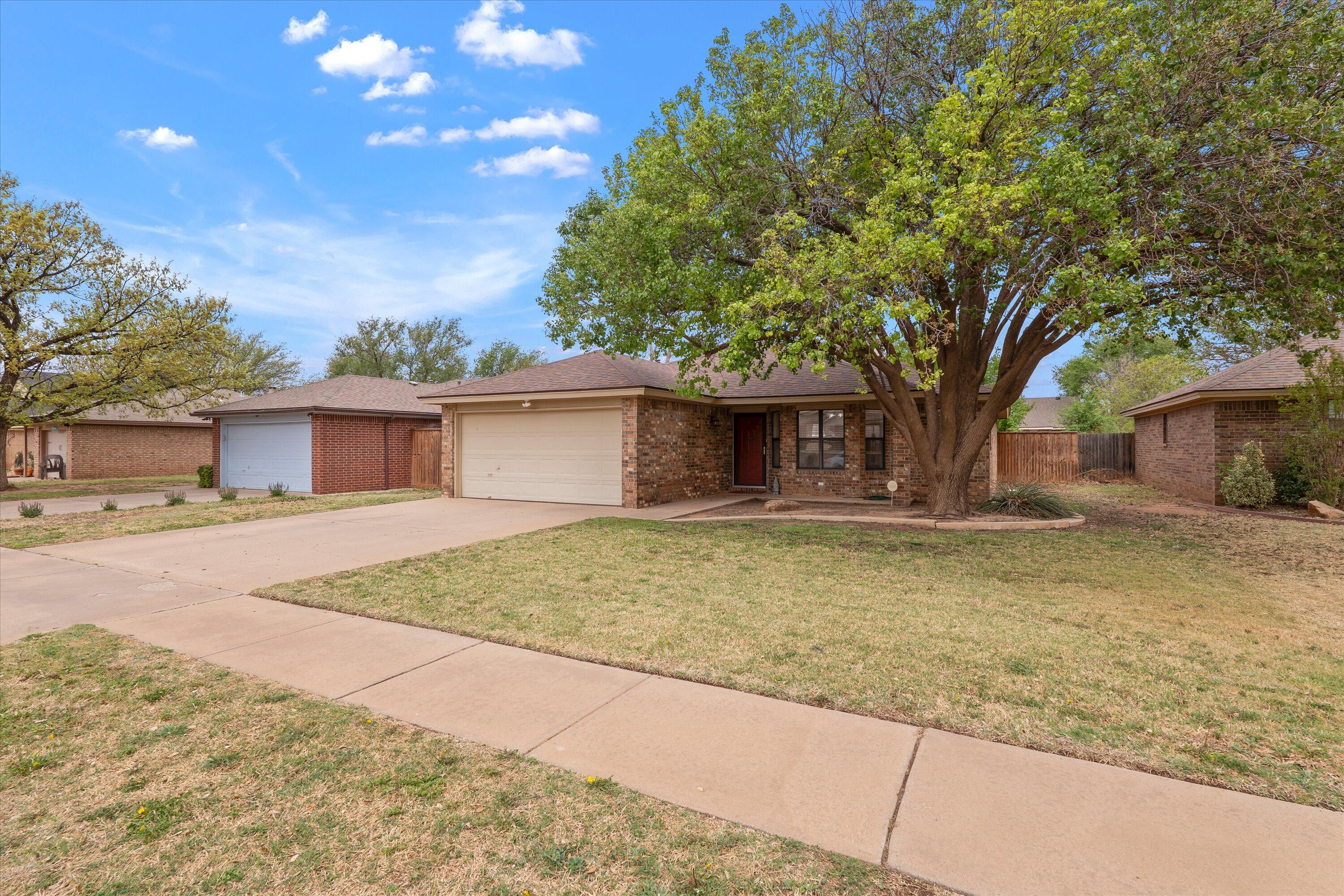 2308 93rd Street Lubbock, TX 79423 - Photo 3 of 28 a backyard of a house with table and chairs