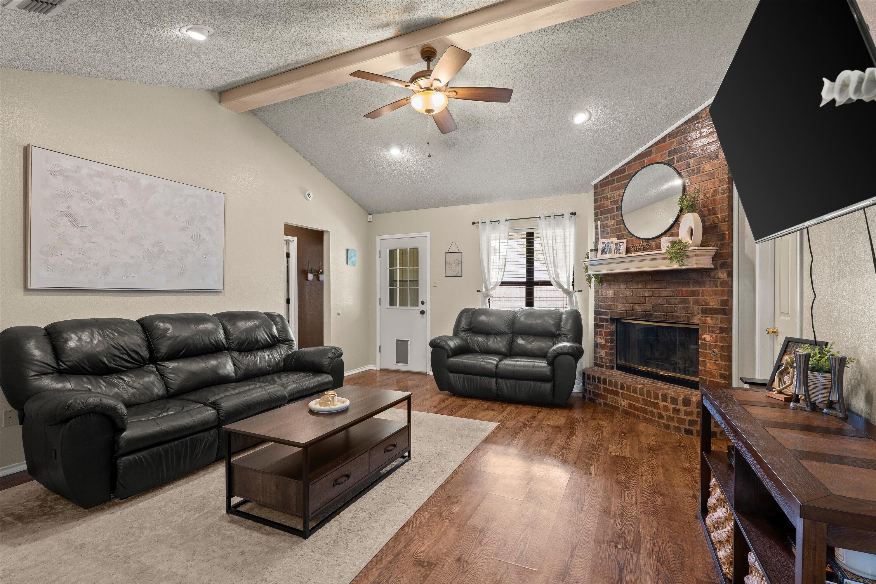 2308 93rd Street Lubbock, TX 79423 - Photo 6 of 28 a living room with furniture and a fireplace