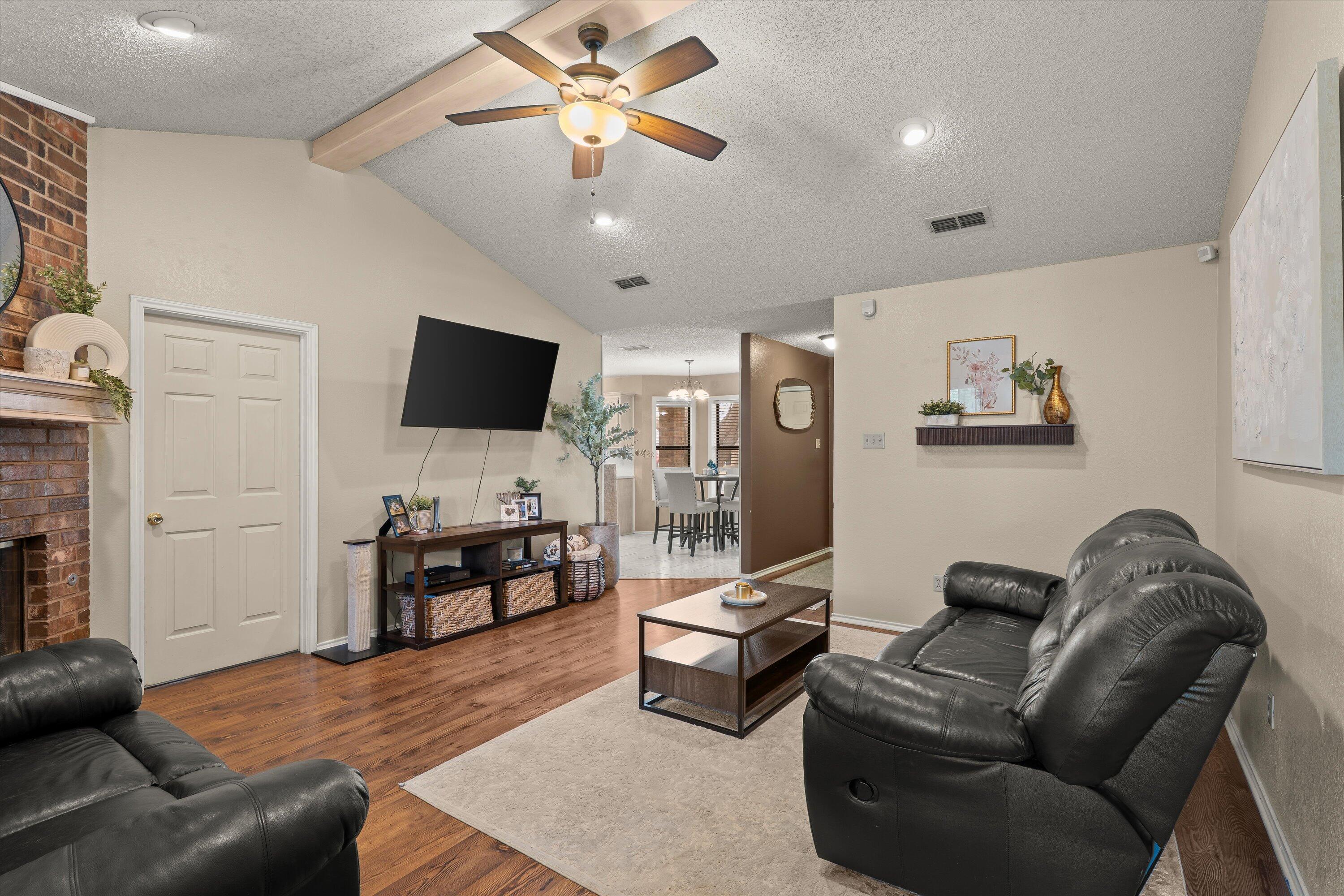 2308 93rd Street Lubbock, TX 79423 - Photo 8 of 28 a living room with furniture and a flat screen tv
