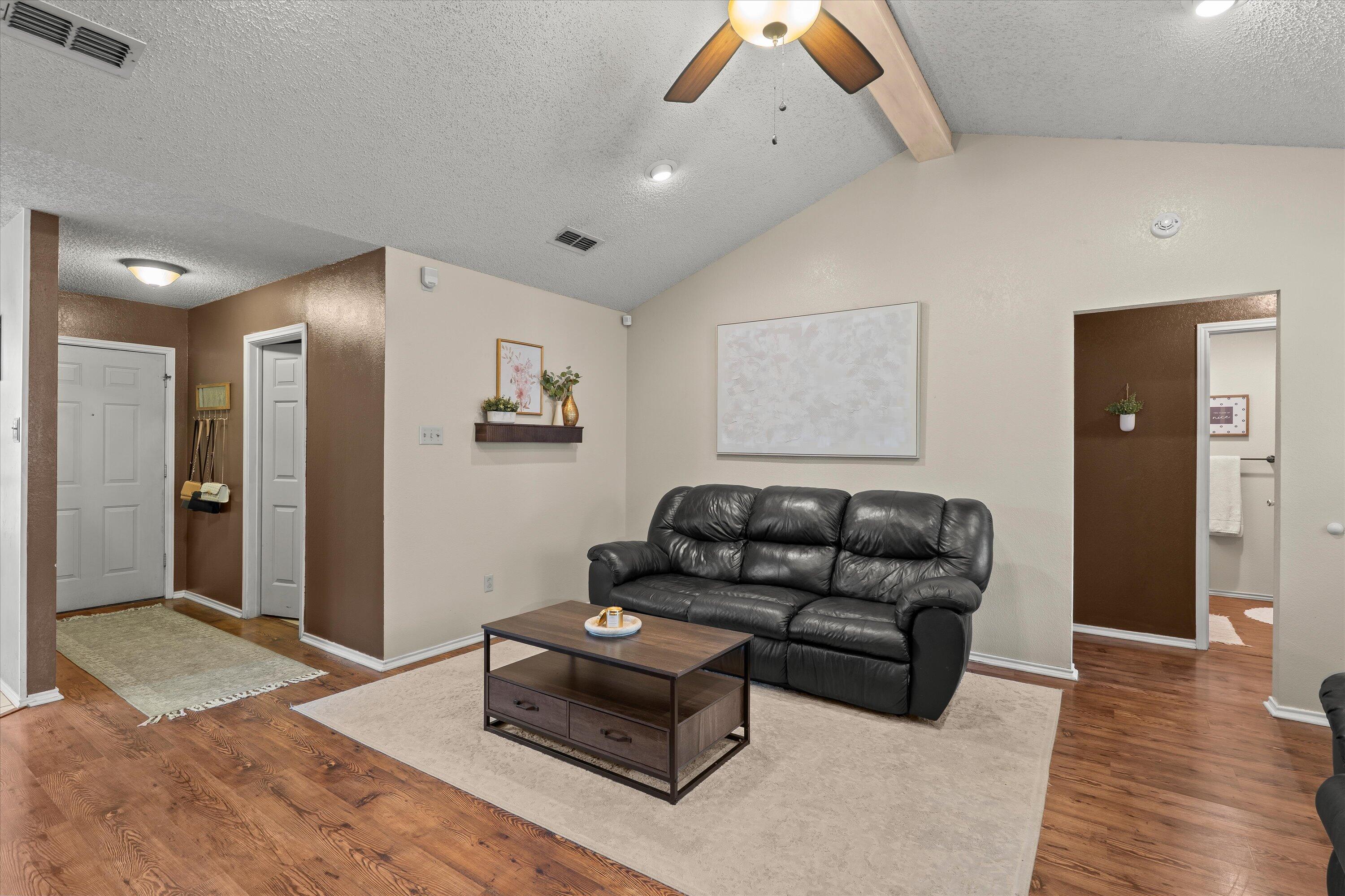 2308 93rd Street Lubbock, TX 79423 - Photo 9 of 28 a living room with furniture and a ceiling fan