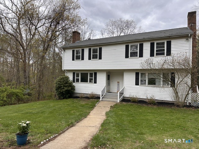 a front view of a house with a garden
