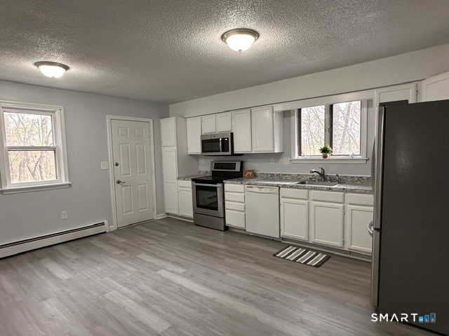 259 Westchester Road, Unit A Colchester, CT 06415 - Photo 5 of 22 a kitchen with granite countertop a refrigerator stove top oven and sink