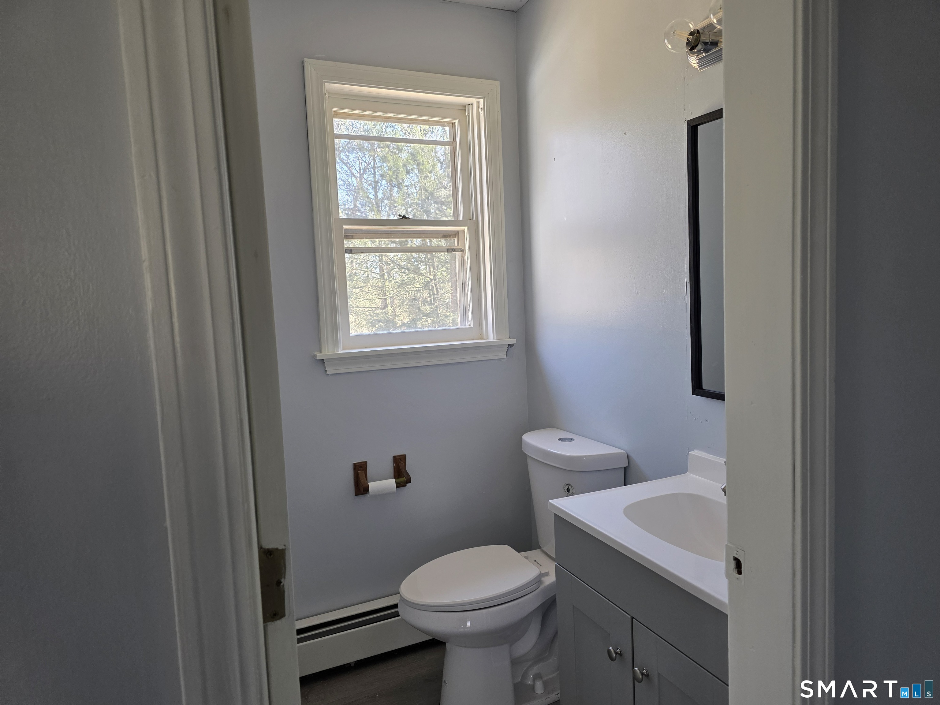 259 Westchester Road, Unit A Colchester, CT 06415 - Photo 9 of 22 a bathroom with a toilet sink and mirror