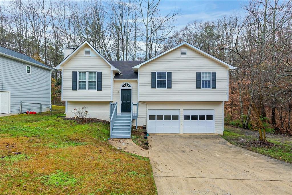 104 Brookside Drive Dallas, GA 30132 - Photo 1 of 1 a view of a house with a yard and garage