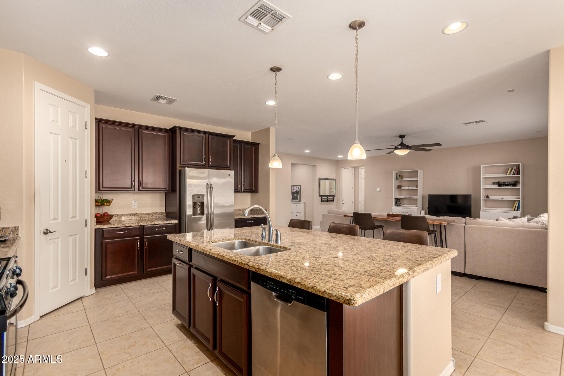 3294 North Springfield Street Buckeye, AZ 85396 - Photo 13 of 43 a kitchen with kitchen island granite countertop a sink counter top space appliances and cabinets