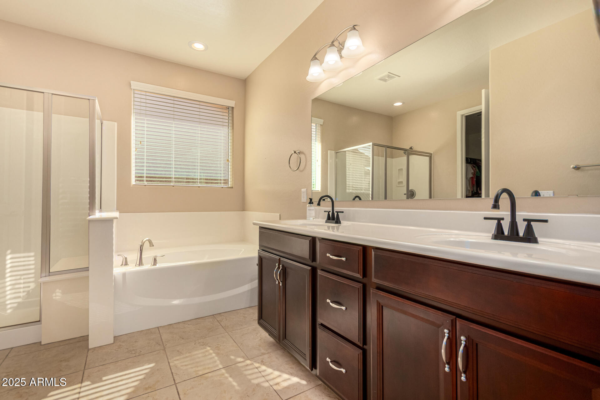 3294 North Springfield Street Buckeye, AZ 85396 - Photo 18 of 43 a bathroom with a tub a sink double vanity and a mirror