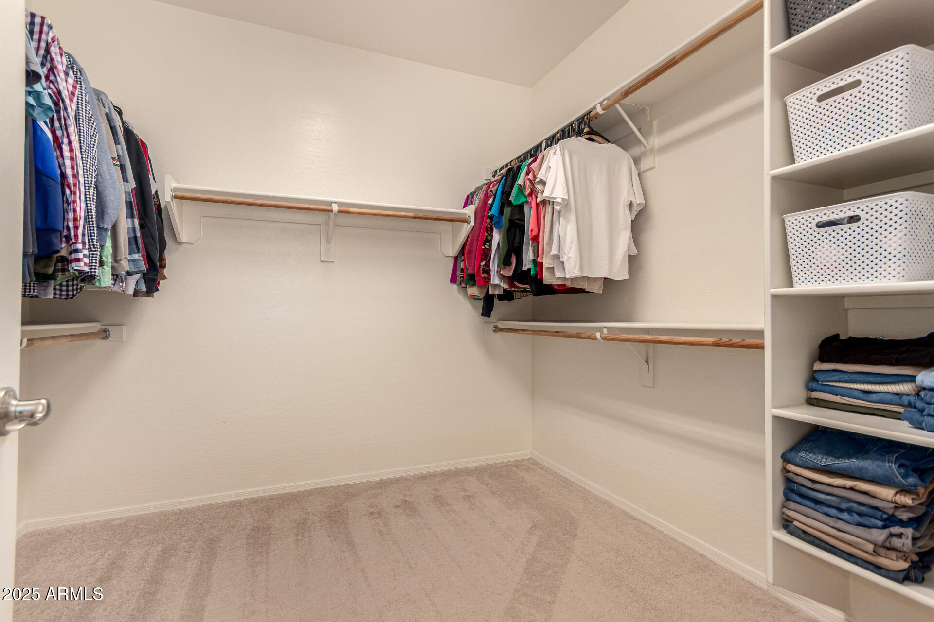 3294 North Springfield Street Buckeye, AZ 85396 - Photo 20 of 43 a view of walk in closet with clothes and shoes