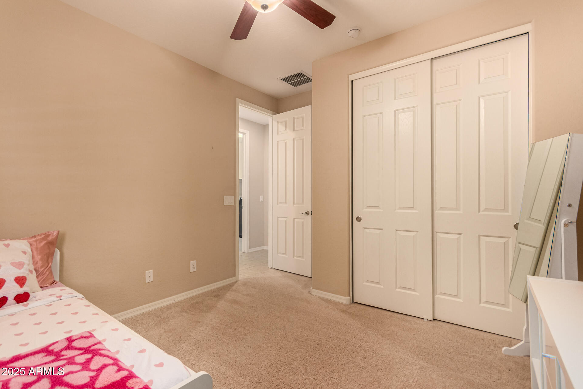 3294 North Springfield Street Buckeye, AZ 85396 - Photo 22 of 43 a bedroom with a bed and a chandelier fan