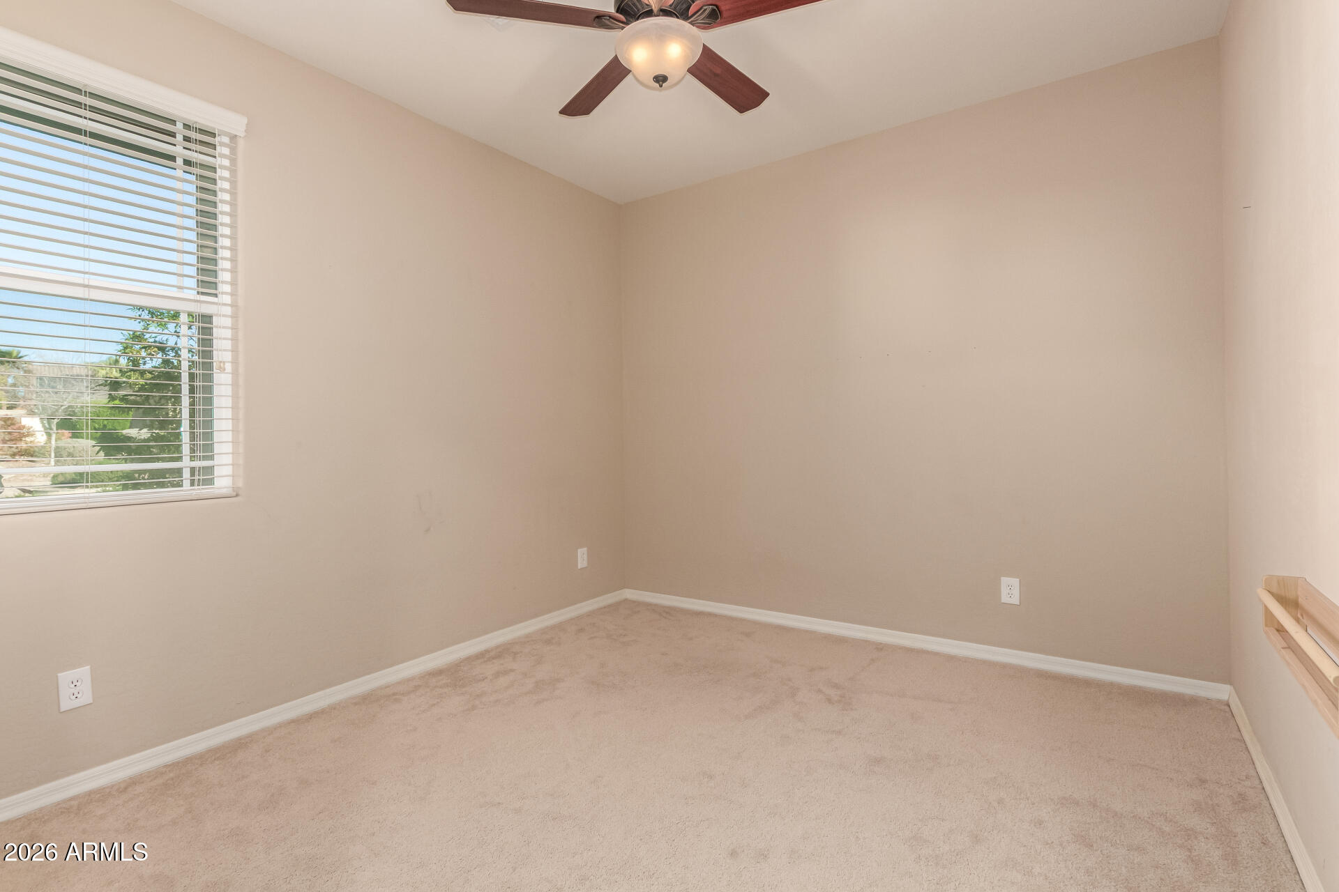 3294 North Springfield Street Buckeye, AZ 85396 - Photo 23 of 43 an empty room with a window and a fan