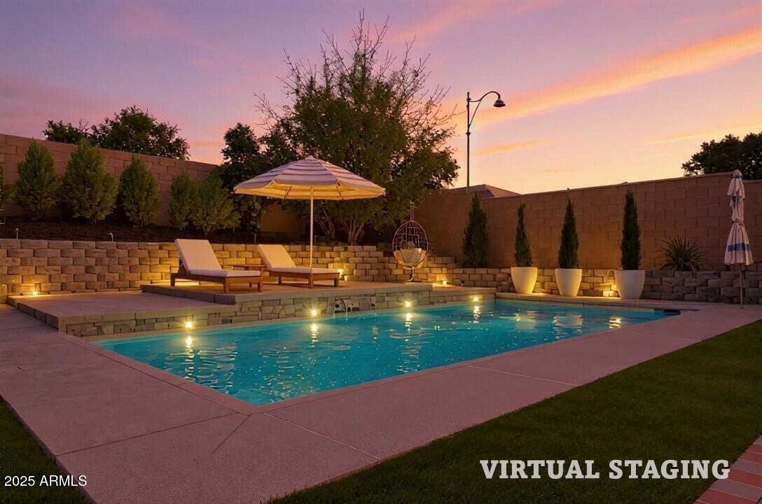 3294 North Springfield Street Buckeye, AZ 85396 - Photo 4 of 43 a view of a swimming pool with a table and chairs under an umbrella