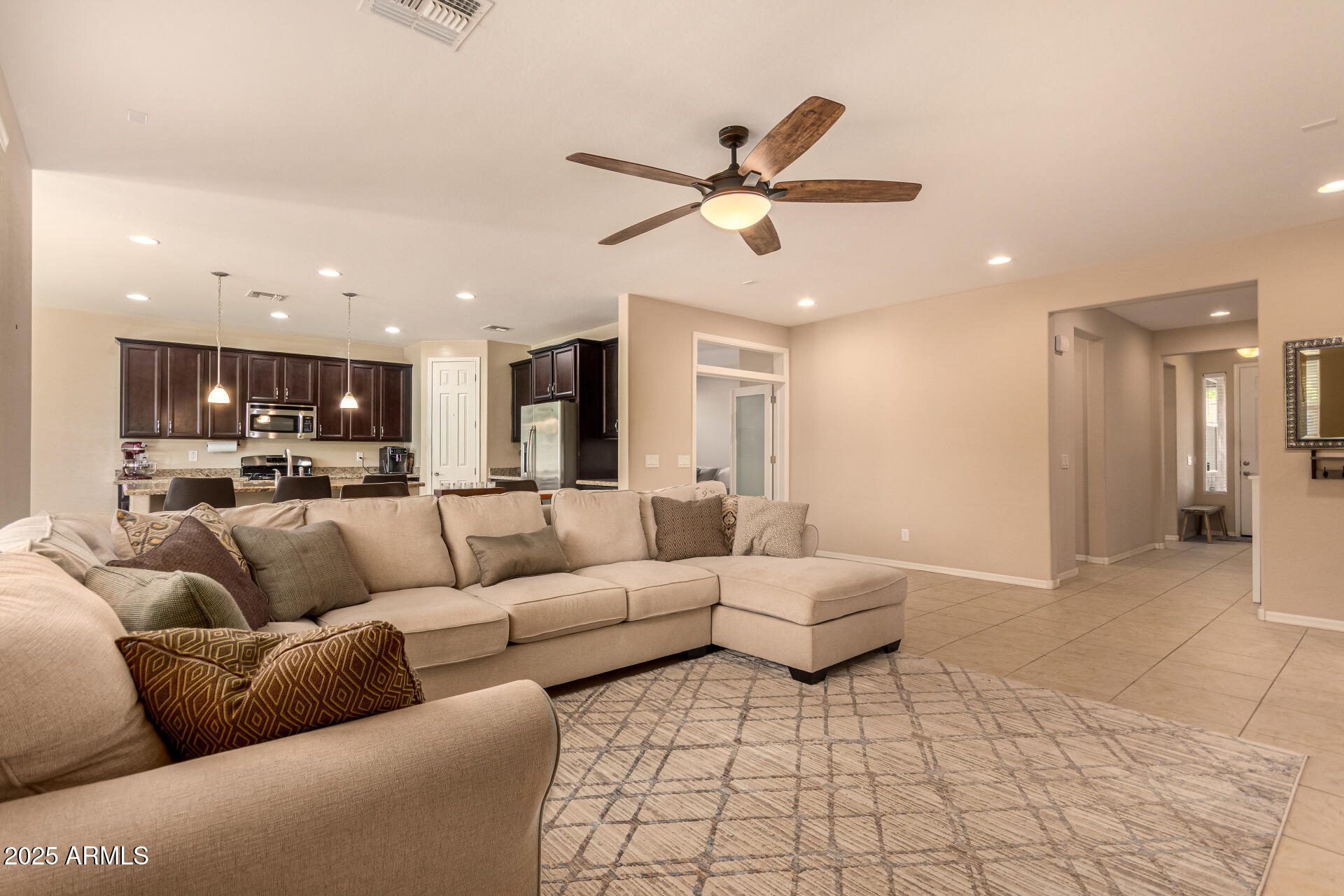 3294 North Springfield Street Buckeye, AZ 85396 - Photo 7 of 43 a living room with furniture and a view of kitchen