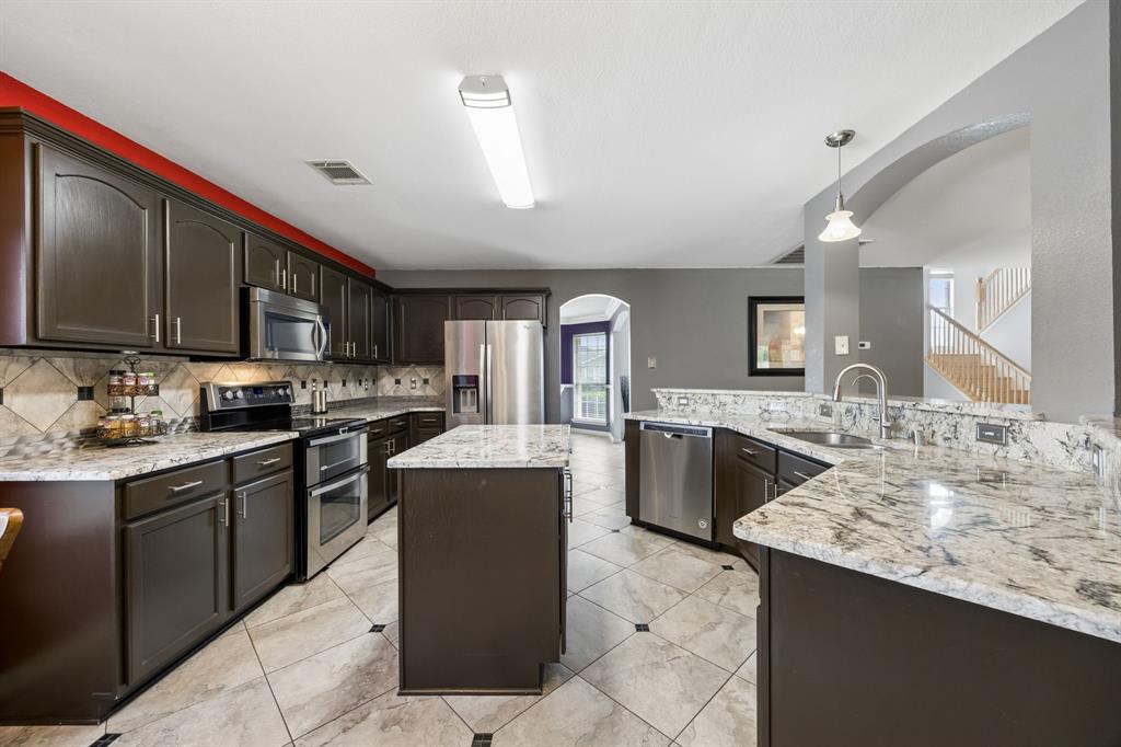 545 Rothschild Lane Murphy, TX 75094 - Photo 7 of 27 Large kitchen with plenty of granite counters and island.