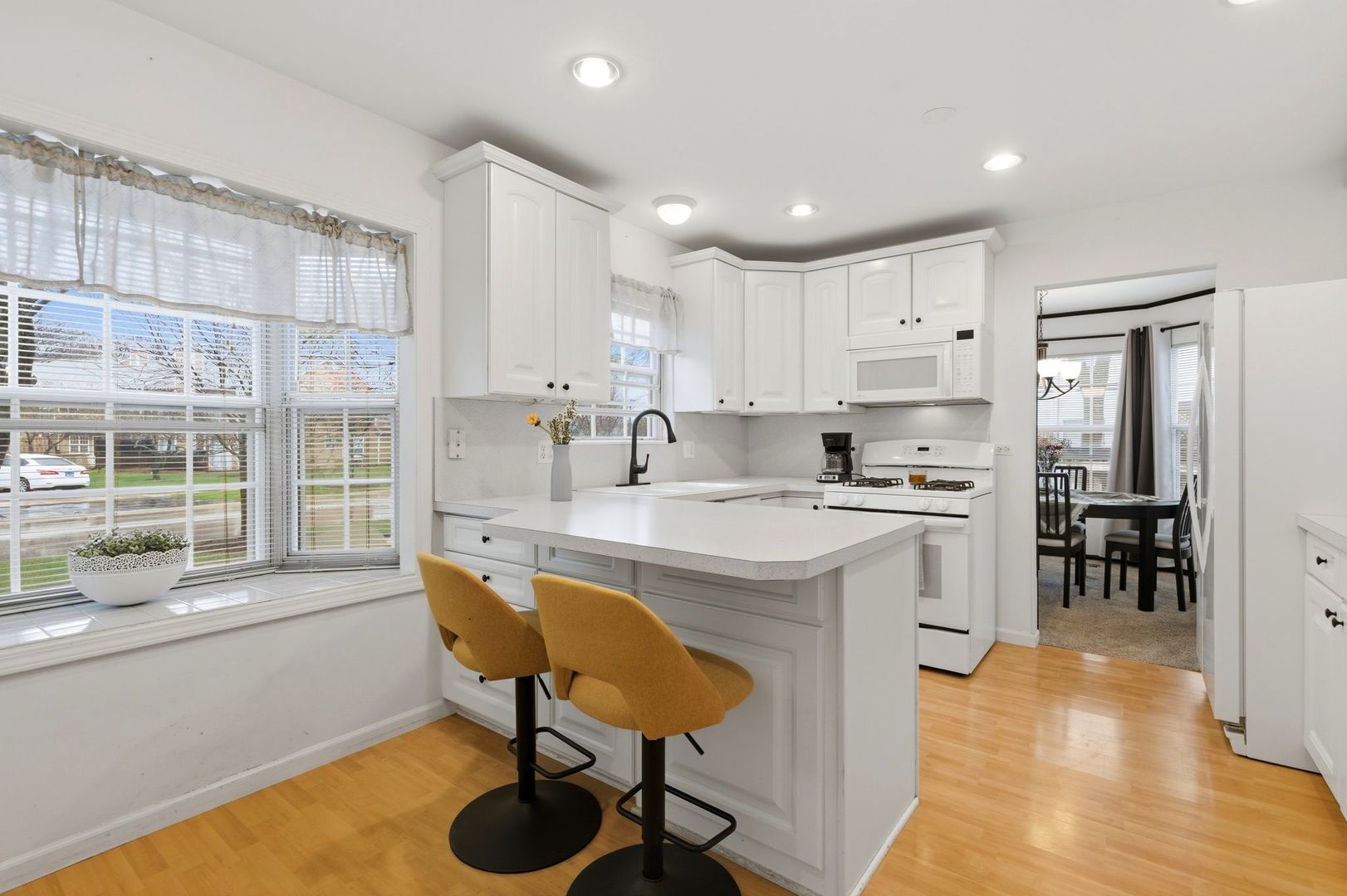450 Ascot Lane Streamwood, IL 60107 - Photo 11 of 27 a kitchen with stainless steel appliances granite countertop a sink and a refrigerator