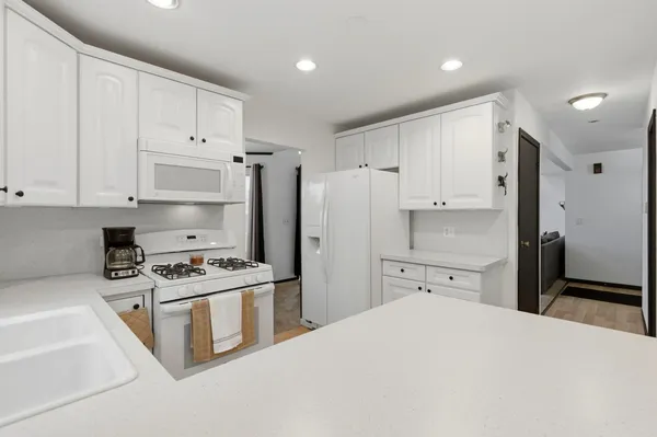 a kitchen with stainless steel appliances a refrigerator sink and cabinets