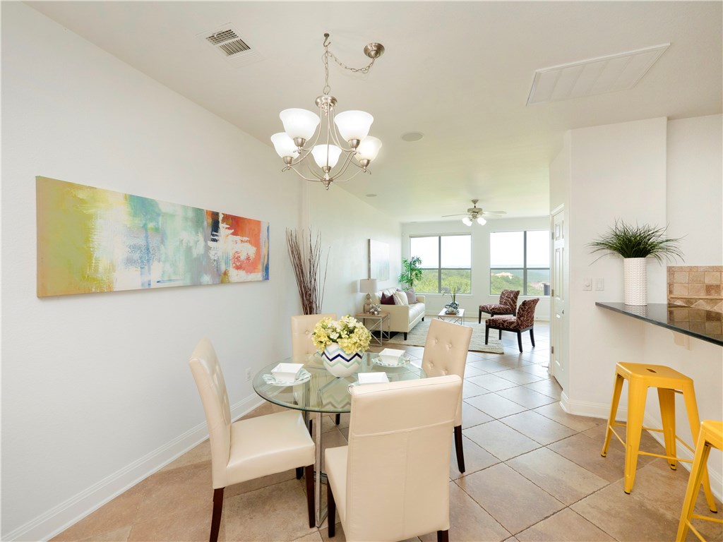 105 Sunrise Ridge Cove Austin, TX 78738 - Photo 1 of 1 a view of a dining room with furniture and chandelier