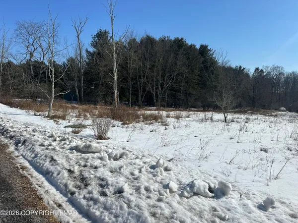 a view of snow on the side of a road