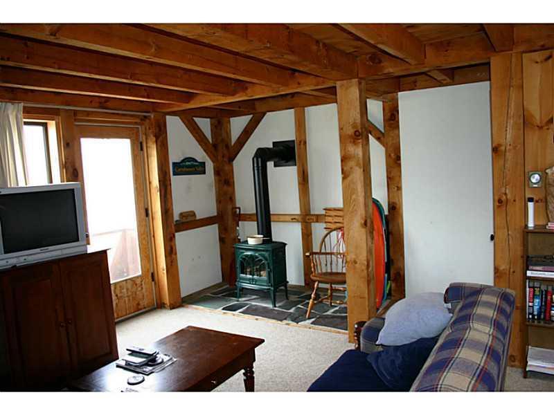 604 Webber Street, Unit 604 Kingfield, ME 04947 - Photo 4 of 14 Living Room. Jotul Gas Stove