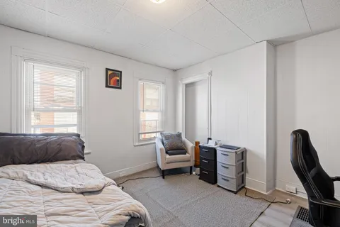 a bed sitting in a bedroom next to a window