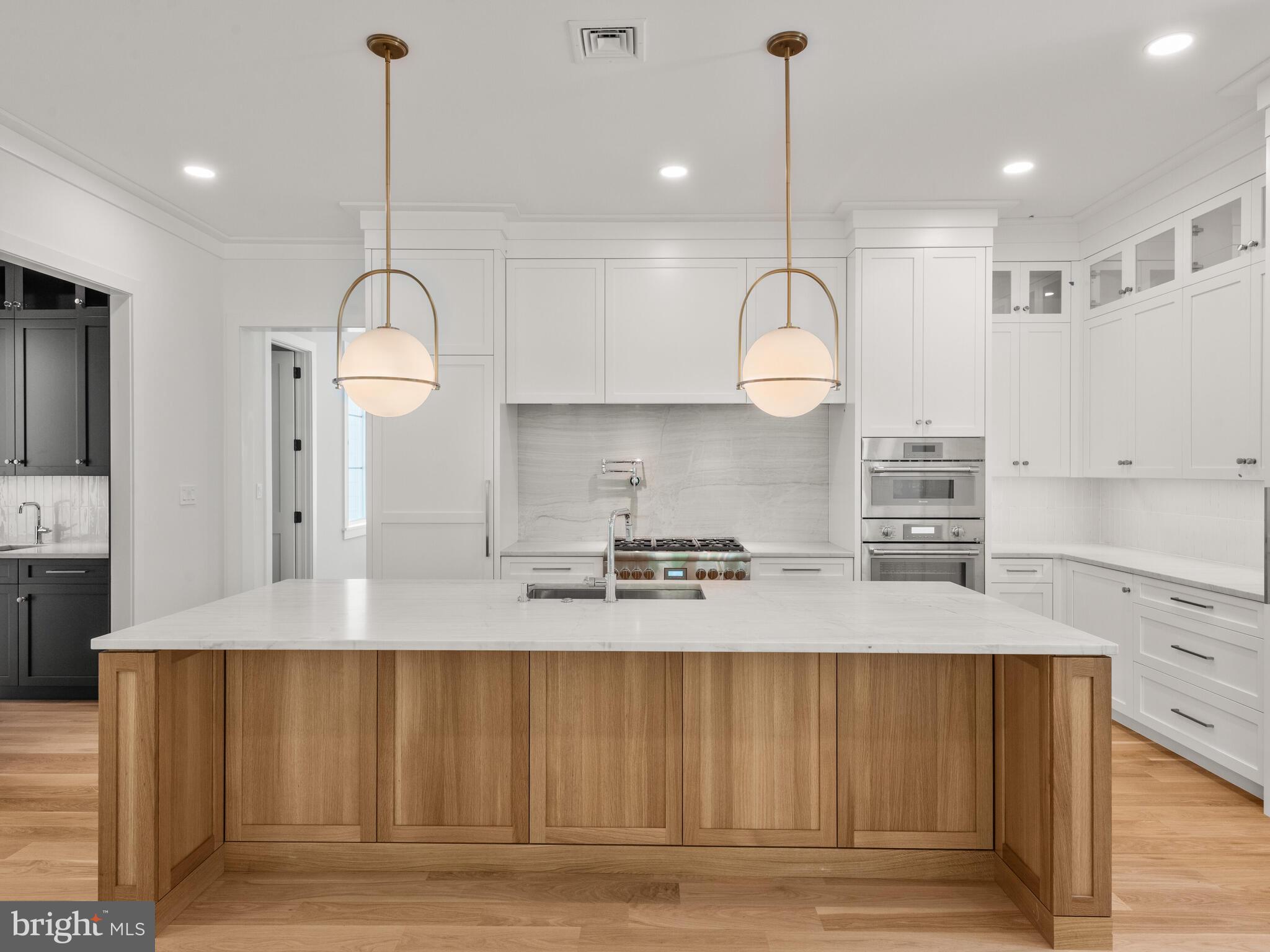 29 Sandringham Road Bala Cynwyd, PA 19004 - Photo 13 of 29 a kitchen with kitchen island granite countertop a stove a sink and a wooden floors