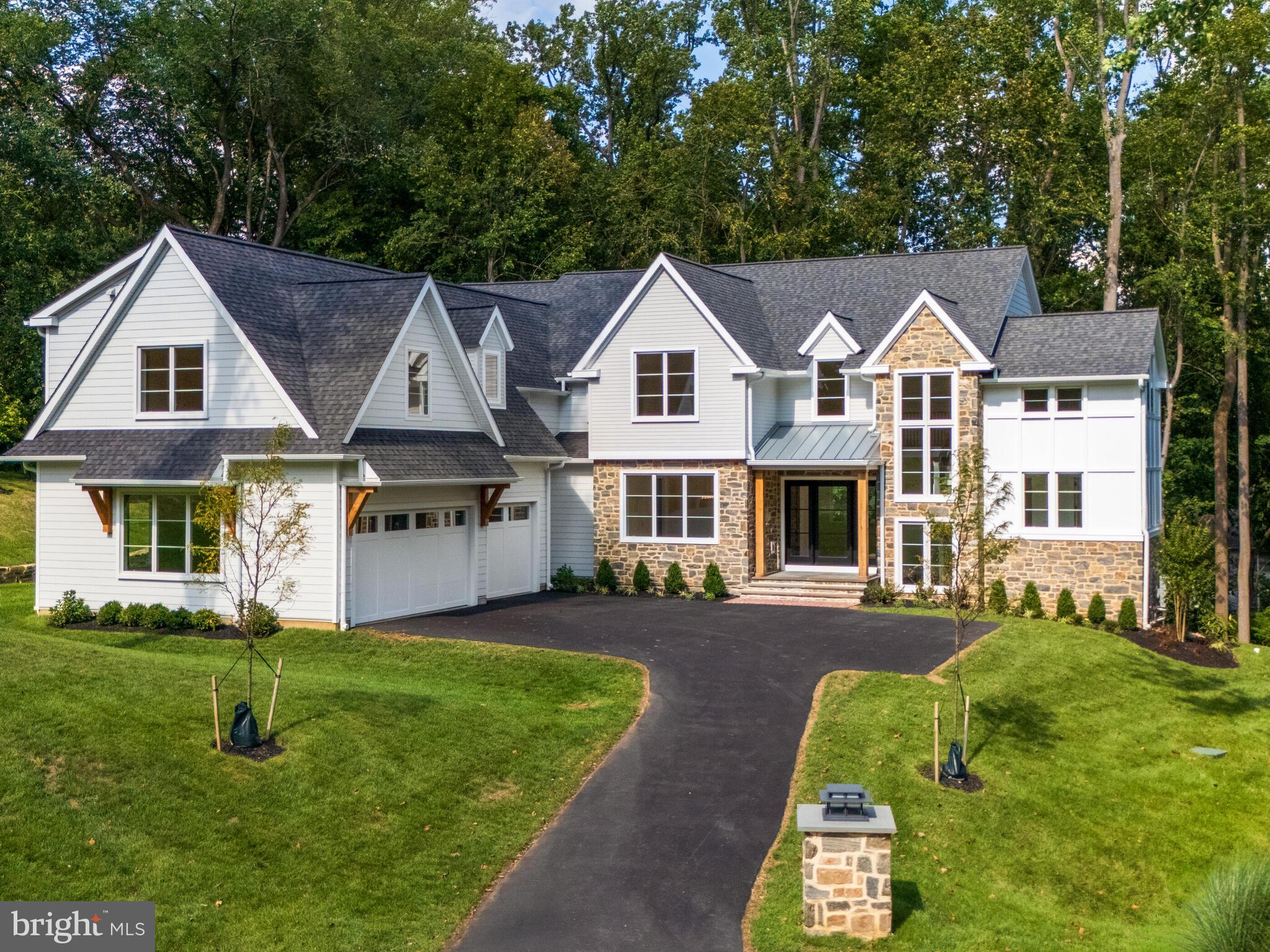 29 Sandringham Road Bala Cynwyd, PA 19004 - Photo 6 of 29 a front view of a house with a yard table and chairs