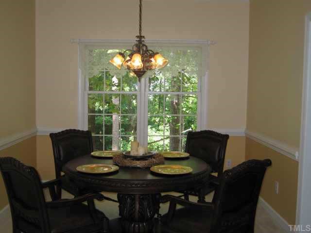 5616 Raddington Street Raleigh, NC 27613 - Photo 3 of 10 a view of a dining room with furniture window and outside view